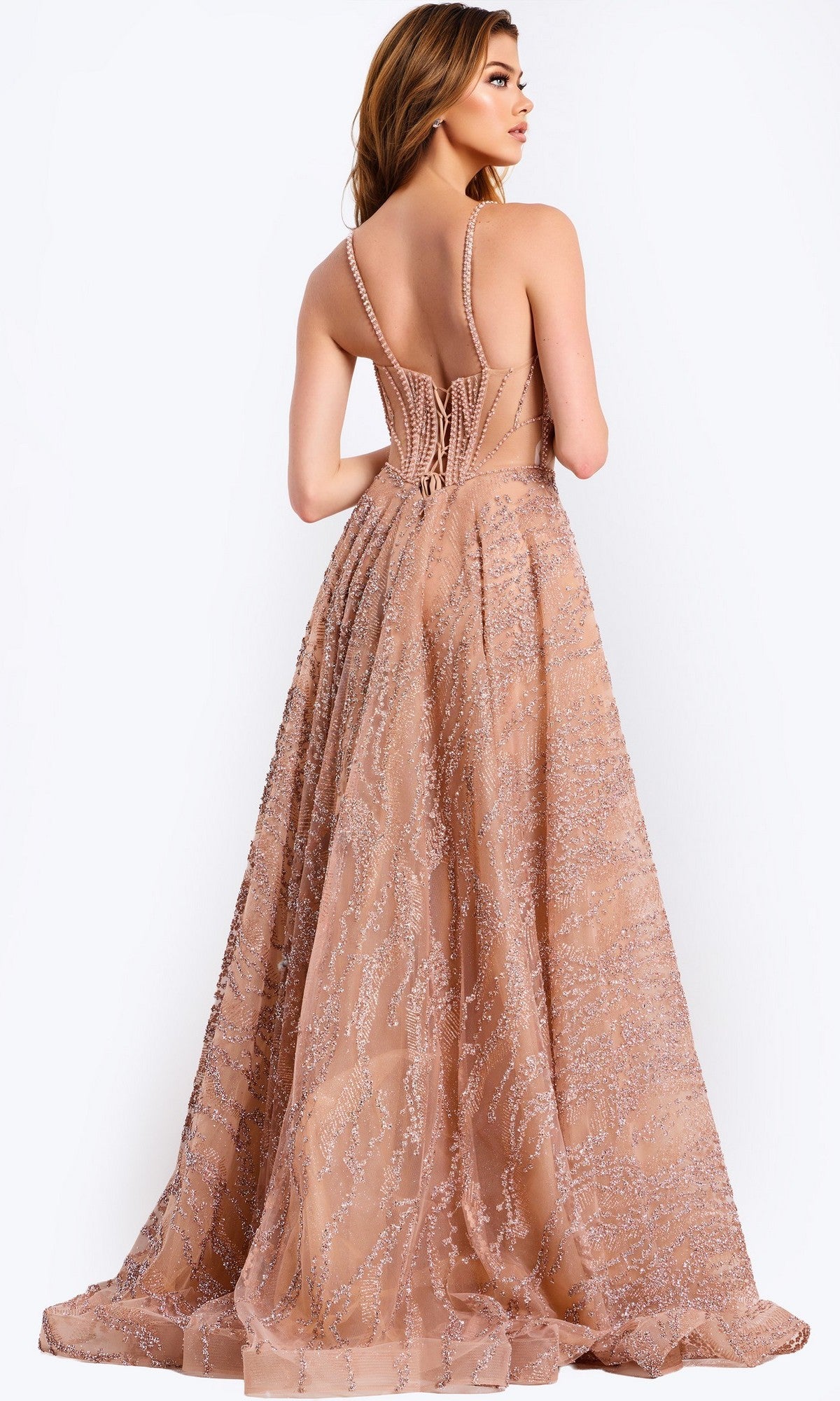A woman models the Jovani 48365 long prom dress, featuring a sleeveless nude beaded tulle skirt, glittery accents, and an elegant sheer corset bodice with a striking corset-style back.